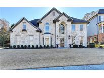 Two-story brick home with landscaped lawn at 3350 Vista Creek Dr, Dacula, GA 30019