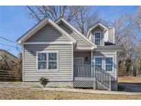 Gray house with white trim, steps, and landscaping at 960 N Grand Nw Ave, Atlanta, GA 30318