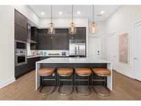 Modern kitchen with stainless steel appliances and a large island at 40 12Th Ne St # 1004, Atlanta, GA 30309