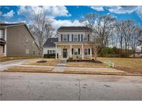 Two-story house with front porch, landscaped yard, and driveway at 340 New Alcovy Rd, Social Circle, GA 30025