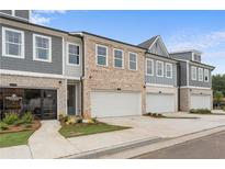 Modern townhouses with attached garages and landscaping at 1032 Rose Dr, Marietta, GA 30060