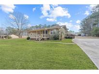 Ranch style home with large yard and paved driveway at 400 Fleeta Dr, Covington, GA 30016