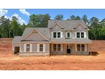 Two story home featuring a gray exterior, white trim, and a covered front porch on a spacious lot at 1257 Pj East Rd, Covington, GA 30014