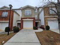 Brick front townhouse with attached garage and landscaping at 4221 Sw Notting Hill Sw Dr, Atlanta, GA 30331