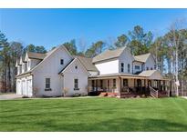 Two-story farmhouse with wrap-around porch and expansive lawn at 3505 Moss Landing Rd, Acworth, GA 30102