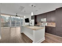 Modern kitchen features an island with marble countertops, stainless steel appliances, and an open floor plan at 1080 Peachtree Ne St # 804, Atlanta, GA 30309