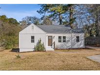 Charming renovated home with white siding and a spacious lawn at 1664 Columbia Dr, Decatur, GA 30032