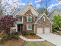 Charming two-story home with brick and stone accents, and a well-manicured lawn at 5575 Twelve Oaks Dr, Cumming, GA 30028
