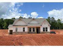 New construction home with a brick foundation, light siding, and a gray shingled roof sits on a bare lot at 1275 Pj East Rd, Covington, GA 30014