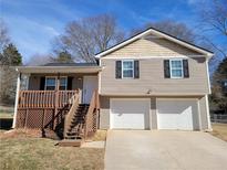 Two-story house with a two-car garage and wooden deck at 2043 Laird Rd, Hiram, GA 30141