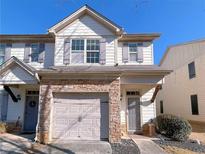 Two-story townhome with stone accents and a two-car garage at 4222 High Park Ln, Atlanta, GA 30344