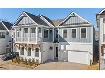 Two-story home with gray siding, white trim, and a two-car garage at 89 Batten Board Way, Woodstock, GA 30189