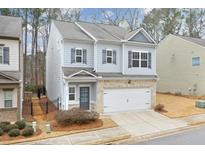 Two-story house with gray siding, brick accents, and a two-car garage at 236 Hickory Commons Way, Canton, GA 30115