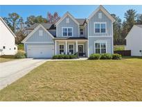 Two-story farmhouse with gray siding, white trim, and a landscaped lawn at 2044 Garvin Rd, Acworth, GA 30101