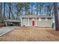 Ranch style home with carport and red front door at 2876 Battle Forrest Dr, Decatur, GA 30034