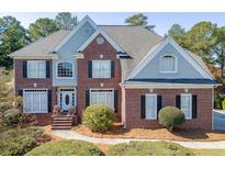 Two-story brick home with gray accents and landscaped yard at 2555 Lynshire Ln, Snellville, GA 30078