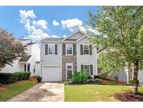 Two-story house with gray siding, stone accents, and a grassy front yard at 5140 Sky Ridge Way, Cumming, GA 30041
