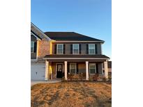 Two-story home with brick and siding, a front porch, and a landscaped yard at 221 Overlook Rd, Covington, GA 30014