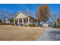 Charming craftsman home with a spacious lawn and long driveway at 5143 Floyd Ne St, Covington, GA 30014