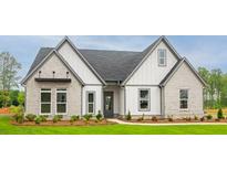 Two-story house with gray and white exterior, landscaping, and a spacious lawn at 6315 Wallace Farms Dr, Cumming, GA 30028