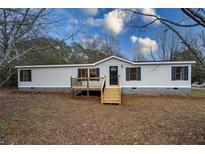 Newly renovated single-wide mobile home with new deck and landscaping at 1326 Elm Cir, Stockbridge, GA 30281