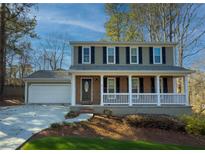 Two-story house with a brick facade, white porch, and a two-car garage at 601 Ashton Ln, Lawrenceville, GA 30044