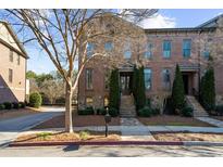 Brick front exterior of townhome with stone accents and a charming walkway at 2022 Heathermere Way, Roswell, GA 30075