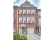 Brick front exterior of a two-story townhome with a two-car garage at 5146 Manerdale Se Dr # 4, Atlanta, GA 30339