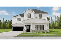 Two-story farmhouse with white siding, black windows, and a stone facade at 614 Charlotte Pl Nw, Atlanta, GA 30318