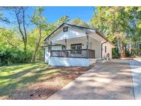 Newly renovated house featuring a front porch and driveway at 1679 Hollyhock Ter, Decatur, GA 30032