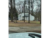 Two-story house with white siding, black accents, and a deck at 702 Talemwood Ct, Lawrenceville, GA 30044