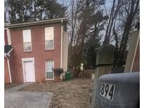 Brick townhouse with a small front yard and mailbox at 894 Glynn Oaks Dr, Clarkston, GA 30021