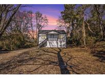 Charming exterior of a house with a porch and landscaped front yard under a beautiful sky at 1490 Broad Ne St, Conyers, GA 30012