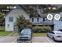 Two-unit property featuring a white and blue house with parking at 410 Prince Of Wales, Stone Mountain, GA 30083