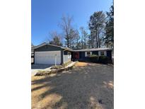 Charming single-story home with a well-manicured front yard, garage, and inviting front entrance at 3422 Sweetwater Dr, Lawrenceville, GA 30044