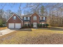 Brick two-story house with attached two-car garage and a spacious yard at 429 Karli Ct, Mcdonough, GA 30253