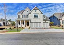 Two-story house with gray siding, three-car garage, and landscaped yard at 11255 Knollwood Bnd, Johns Creek, GA 30097