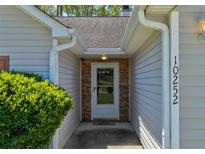 Inviting front entrance featuring stone accents and updated exterior features at 10252 Commons Xing, Jonesboro, GA 30238