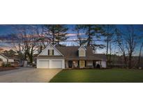 Two-story house with a three-car garage and landscaped lawn at 159 Sequoyah Cir, Canton, GA 30115