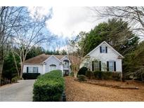 Two-story house with a landscaped yard and driveway at 3955 Three Chimneys Ln, Cumming, GA 30041