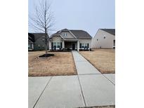 Two-story house with light beige siding, walkway, and landscaping at 408 Blue Sky Cir, Acworth, GA 30102