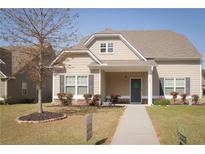Charming single-Gathering home featuring a welcoming front porch, manicured lawn, and inviting curb appeal at 408 Blue Sky Cir, Acworth, GA 30102