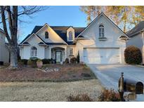 All-brick home with landscaped yard, two-car garage, and inviting front porch at 1814 Tristan Se Dr, Smyrna, GA 30080