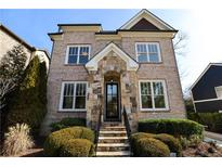 Two-story brick home with stone accents and landscaped yard at 2455 Ellijay Ne Dr, Brookhaven, GA 30319