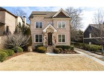 Two-story brick home with stone accents and a landscaped yard at 2455 Ellijay Ne Dr, Brookhaven, GA 30319