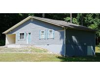 Ranch style home with gray siding, shutters, and a partially finished basement at 2850 Rhett Butler Dr, Douglasville, GA 30135