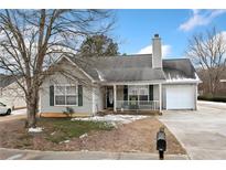 Ranch style home with attached garage and front porch at 6715 Biscayne Blvd, Rex, GA 30273