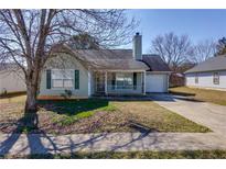 Charming single-Gathering home with a well-maintained front yard, driveway, and inviting front porch at 6715 Biscayne Blvd, Rex, GA 30273