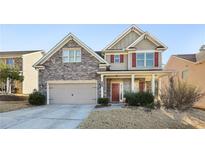 Two-story house with stone accents and a large front yard at 1537 Balvaird Dr, Lawrenceville, GA 30045