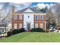 Brick two-story house with a manicured lawn at 63 Habersham Cove Nw Ln, Atlanta, GA 30305